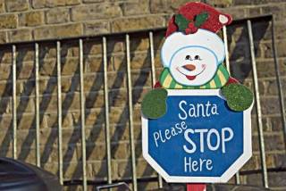  santa please stop here sign in a residential garden in twickenham , middlesex , england 