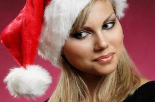  Stock photo of a Smiling young happy woman in a red Christmas hat emotional artistic close up portrait Isolated on red background Xmas holidays anticipation concept Twenty year old caucasian woman 