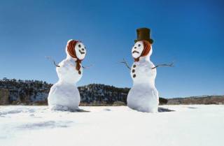  A snowman and snowwoman in a field near Glorieta , New Mexico , at Christmas 