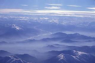  Aerial view of river flowing from snow covered Andes mountains in winter , Santiago ( near ) , Chile 